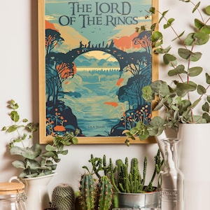 May include: A framed poster with a vintage illustration of a bridge and forest scene. The poster features the text "The Lord of the Rings" and "J.R.R. Tolkien". The poster is surrounded by plants and a camera.