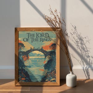 May include: A framed poster with a vintage illustration of a bridge in a forest. The poster has the title "The Lord of the Rings" in a stylized font.