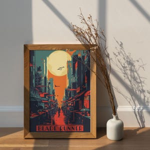 May include: A framed poster with a retro-style illustration of a futuristic cityscape at sunset. The poster is titled "Blade Runner".