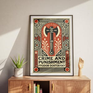 Op de afbeelding: Een ingelijste poster met een rood, zwart en wit ontwerp. De poster toont een illustratie van een bijl met een gestileerd ontwerp. De tekst op de poster luidt "Misdaad en straf" en "Fjodor Dostojevski".