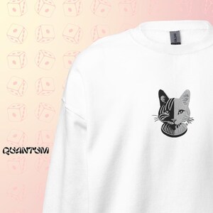 May include: White sweatshirt with a black and white cat graphic on the front. The cat has a split face, one side black and the other white.