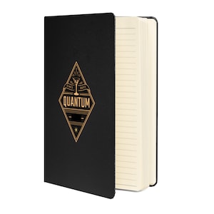 May include: Black leather-bound notebook with gold accents. The front cover features a diamond-shaped logo with the text "SINCE 2013 QUANTUM" and a cocktail glass graphic.