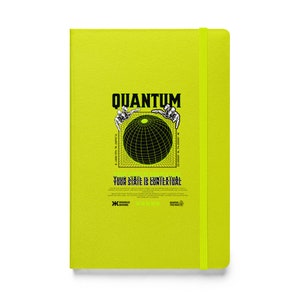 May include: A bright yellow notebook with a black and white graphic of a globe surrounded by hands. The text "QUANTUM" is above the globe and the text "YOUR STATE IS CONTEXTUAL" is below the globe. The notebook has a black elastic band.