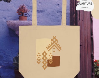 May include: Cream-colored tote bag with a geometric design in shades of tan and brown. The bag has a rectangular shape with a square design on the front. The text "QUANTURE" is printed on the upper right corner.