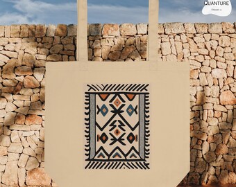 May include: A beige tote bag with a black and white geometric design printed on the front. The design features a rug-like pattern with orange, blue, and gray accents.