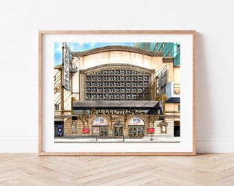 May include: A watercolor painting of the historic Paramount Theatre in New York City. The building is a classic example of Art Deco architecture, with ornate details and a large marquee. The theater is currently showing a production of "Guys and Dolls".