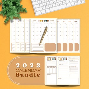 May include: A 2023 calendar bundle with monthly, weekly, and daily planner pages. The monthly pages are white with gold accents and a gold pen. The bundle includes a weekly and daily planner with color-coded sections. The text "2023 Calendar Bundle" is displayed.