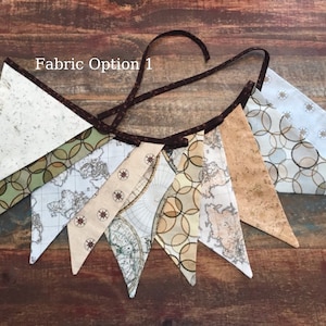 Könnte beinhalten: Ein Stoffbanner mit braunem Besatz und verschiedenen Mustern, darunter eine Weltkarte, Kreise und Sterne. Das Banner ist mit "Fabric Option 1" beschriftet.