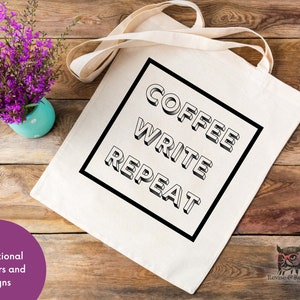 May include: A white canvas tote bag with black text that reads "Coffee Write Repeat" in a bold, blocky font. The text is inside a black square.