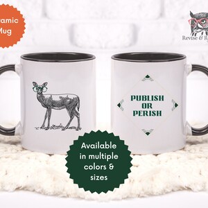 May include: White ceramic mug with a black rim and handle. One side features a black and white illustration of a deer wearing glasses. The other side features the text "PUBLISH OR PERISH" in a green and gold geometric design.