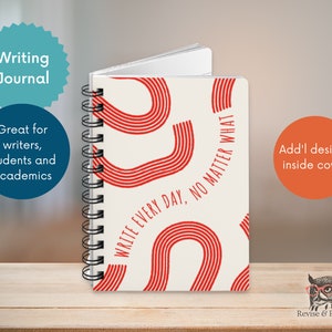 May include: A white spiral bound journal with a red and white abstract design. The cover features the text "WRITE EVERY DAY, NO MATTER WHAT".