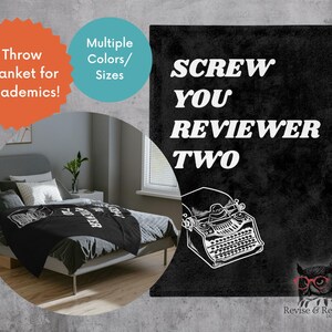 May include: Black throw blanket with the text "SCREW YOU REVIEWER TWO" and a typewriter illustration. The blanket is displayed on a bed in a bedroom setting. The image also includes text that says "Throw Blanket for Academics!" and "Multiple Colors/Sizes."