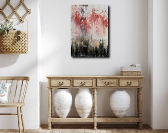 May include: Abstract painting with red, black, white, and gold paint on a canvas. The painting is hanging on a white wall above a wooden console table with three white ceramic vases.