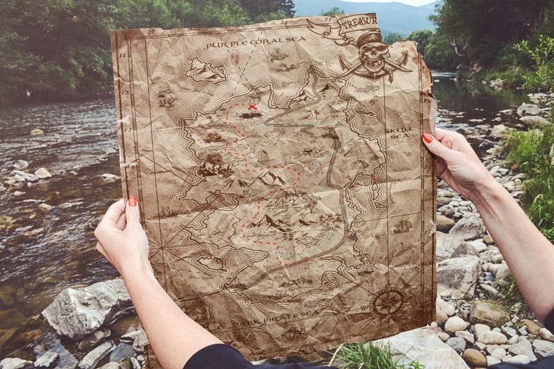 May include: A vintage-style treasure map with a red X marking the spot. The map is labeled "Purple Coral Sea" and "Treasure." The map is held by a person's hands.