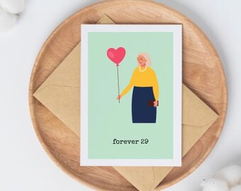 May include: A greeting card with a cartoon illustration of a woman holding a red heart-shaped balloon. The text "forever 29" is printed on the card.