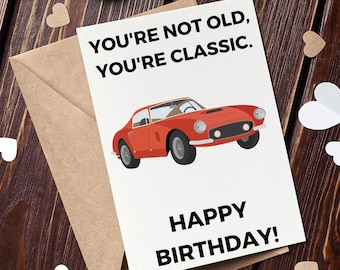 Op de afbeelding: Een witte kaart met een illustratie van een rode sportwagen en de tekst "You're not old, you're classic. Happy Birthday!"