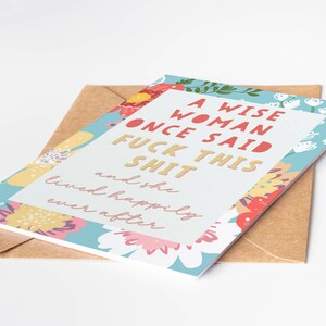 May include: Greeting card with a floral border and the text "A WISE WOMAN ONCE SAID FUCK THIS SHIT and she lived happily ever after." The card is on top of a brown envelope.