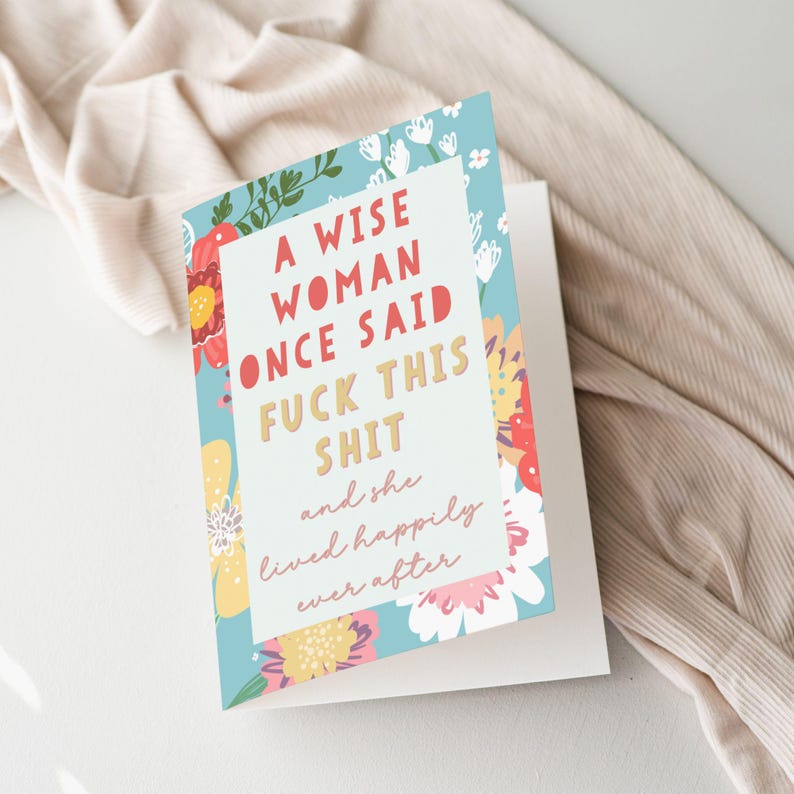 May include: Greeting card with a floral design and the text "A wise woman once said fuck this shit and she lived happily ever after." The card has a white background and a blue floral border.