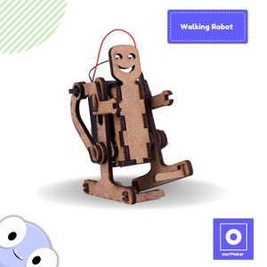 Op de afbeelding: Een houten looprobot-kit met een glimlachend gezicht. De robot is gemaakt van bruin hout en heeft een rode draad eraan bevestigd. De kit is gelabeld met "Walking Robot".