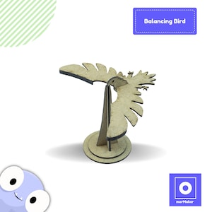 Puede incluir: Un juguete de pájaro de madera para equilibrar. El pájaro es marrón y tiene un diseño simple. El pájaro está equilibrado sobre una pequeña base de madera.