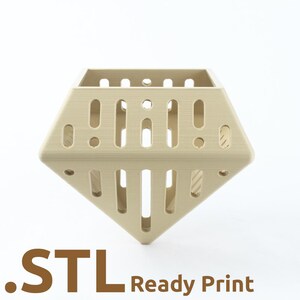 May include: A beige, diamond-shaped 3D-printed object with vertical and circular cutouts. The text ".STL Ready Print" is printed in brown at the bottom of the image. The object has a geometric design.