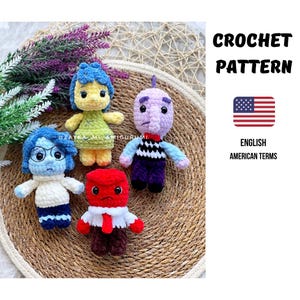 May include: Four crocheted amigurumi dolls, each representing a character from the movie "Inside Out." The dolls are in various colors, including blue, yellow, red, and purple. The image also includes text that says "CROCHET PATTERN" and "ENGLISH AMERICAN TERMS."