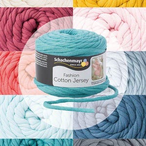 Può includere: Un collage di filato di cotone jersey colorato in varie tonalità, tra cui bianco, giallo, rosa, turchese e blu. Una bobina centrale di filato turchese è etichettata "Fashion Cotton Jersey" di Schachenmayr, un marchio di filati.