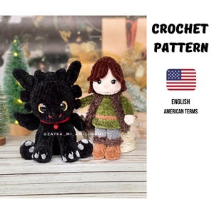May include: A black crocheted dragon and a crocheted character with brown hair, a green shirt, and brown vest. The dragon has yellow eyes and a red collar. The text "CROCHET PATTERN" and "ENGLISH AMERICAN TERMS" are also visible.