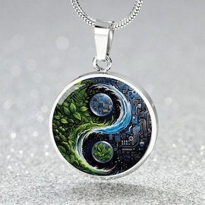May include: A silver-toned circular pendant necklace featuring a yin-yang design. One half displays lush green foliage, while the other half depicts a dark blue electronic circuit board pattern. A small circular inset of leaves sits in the blue section.