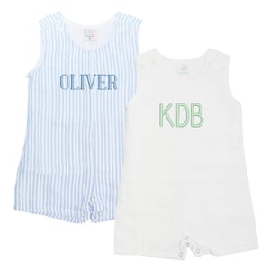 May include: Two white sleeveless baby onesies with blue and white striped fabric and white fabric. The onesies have snaps at the bottom and are personalized with the names "Oliver" and "KDB" in blue and green thread.