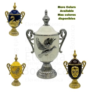 May include: Set of four ceramic decorative urns with gold accents. The urns feature different designs, including a swan, a bird, a face, and a floral pattern. The urns are displayed on a white background.