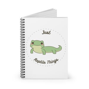 May include: A white spiral notebook with a green cartoon lizard and the text "Just Reptile Things" in a circle.