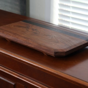 highly figured walnut cutting board with wooden feet image 5