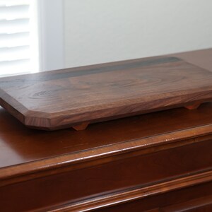 highly figured walnut cutting board with wooden feet image 2