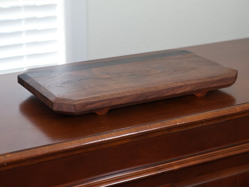 highly figured walnut cutting board with wooden feet image 2