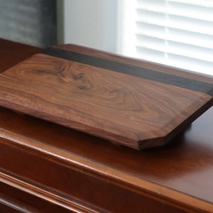 highly figured walnut cutting board with wooden feet image 4