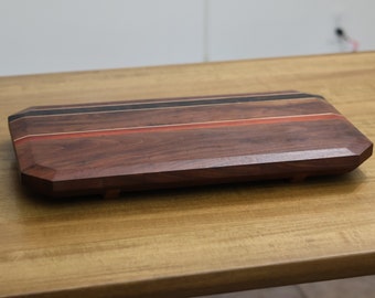 Highly figured walnut cutting board with wooden feet