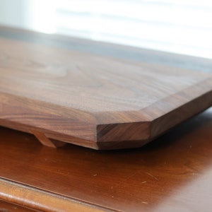 highly figured walnut cutting board with wooden feet image 3