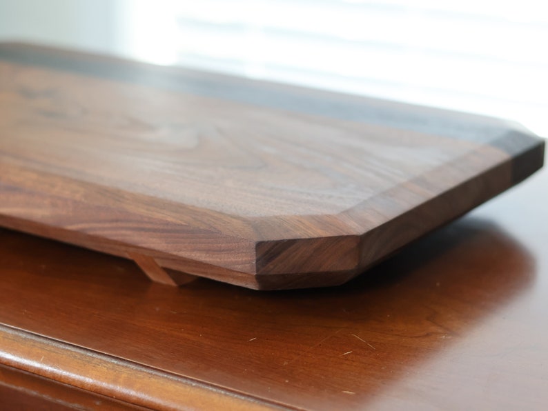 highly figured walnut cutting board with wooden feet image 3