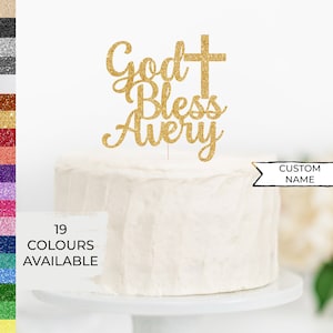 May include: Gold glitter cake topper with the text "God Bless Avery" and a cross. The topper is on a white cake. The text "Custom Name" is on a white banner.