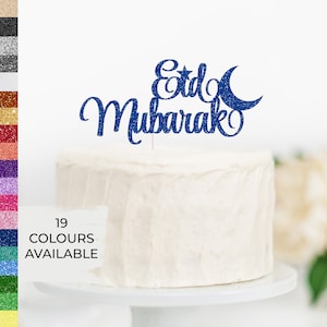 May include: Blue glitter cake topper with the words "Eid Mubarak" and a crescent moon and star.
