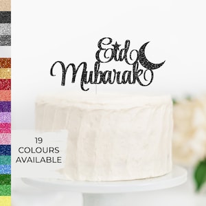May include: Black glitter cake topper with the words "Eid Mubarak" and a crescent moon and star.