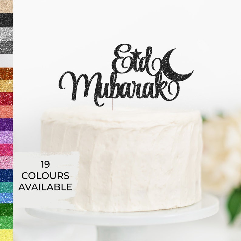 May include: Black glitter cake topper with the words "Eid Mubarak" and a crescent moon and star.