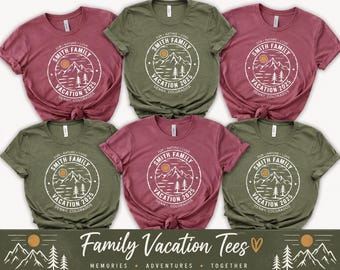May include: Six short-sleeve t-shirts in olive green and mauve colors. Each shirt features a white circular graphic with a mountain range, sun, and pine trees. The text reads: SMITH FAMILY VACATION 2025, FUN NATURE LOVE, and DENNY, COLORADOS.