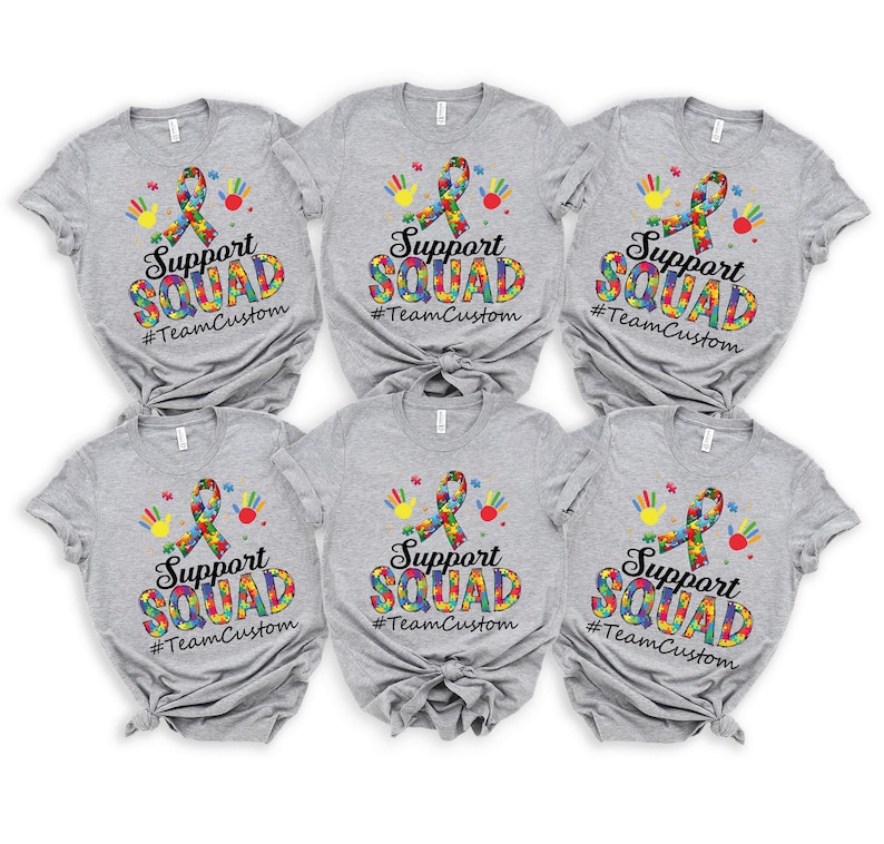 May include: Six gray t-shirts with a colorful puzzle piece ribbon and the text "Support Squad #TeamCustom" printed on the front.