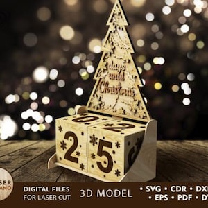 Pode incluir: Um calendário de advento de madeira com um design de árvore cortado a laser. O calendário tem dois blocos numerados que podem ser virados para contar os dias até o Natal. A árvore tem o texto "3 dias até o Natal".