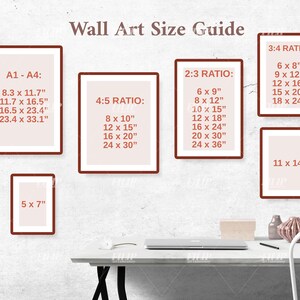 May include: A wall art size guide with different ratios and measurements in inches. The guide is displayed on a white wall with a laptop and a decorative object on a white table.