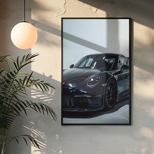 May include: A black Porsche sports car with a black interior, parked in a garage with a white wall and a window behind it. The car is facing the camera and the front headlights are visible.
