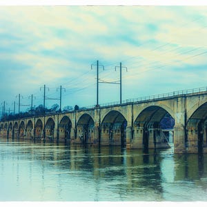 An old arch bridge extending over a river.