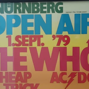 May include: A vintage concert poster for the Nuremberg Open Air show on September 1, 1979, featuring The Who, Cheap Trick, and AC/DC. The poster has a colorful design with text in green, blue, and red.
